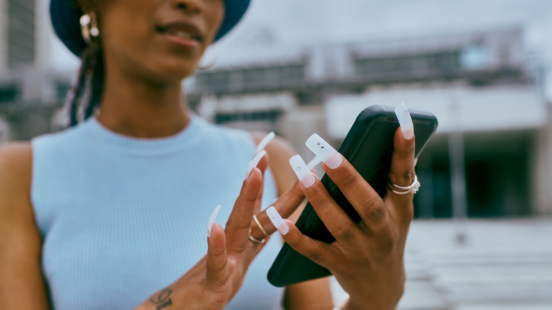 Woman with long nails phone