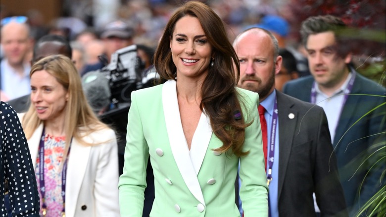 Kate Middleton wearing a light green jacket with white trim at Wimbledon in 2023.