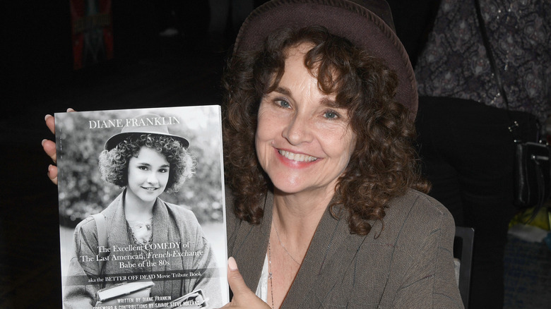 Diane Franklin holding her autobiography.