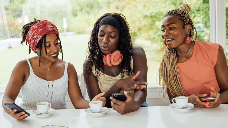 Three women on phones