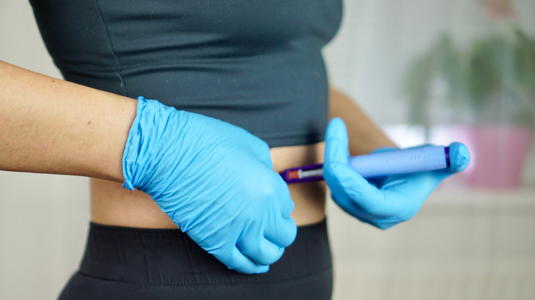 Woman injecting herself