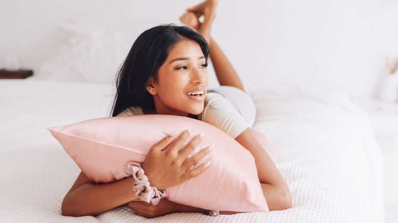 Woman touching hair in terrycloth bathrobe