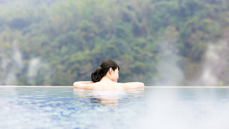 Woman relaxing in thermal bath