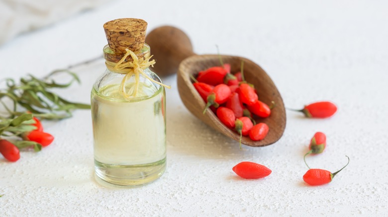 Goji berries next to oil