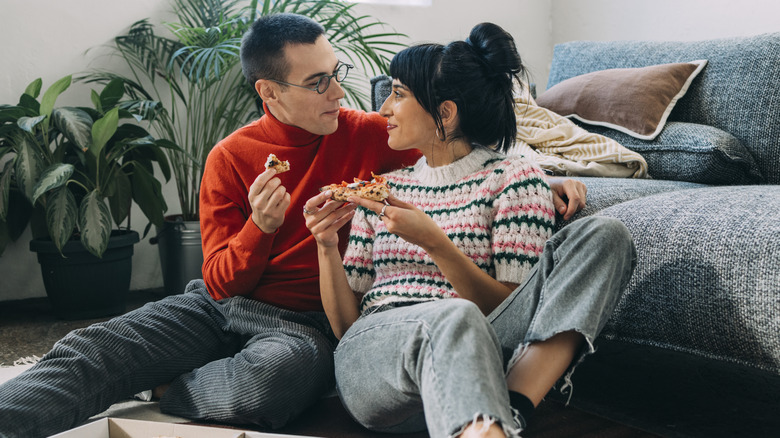 couple sharing pizza at home