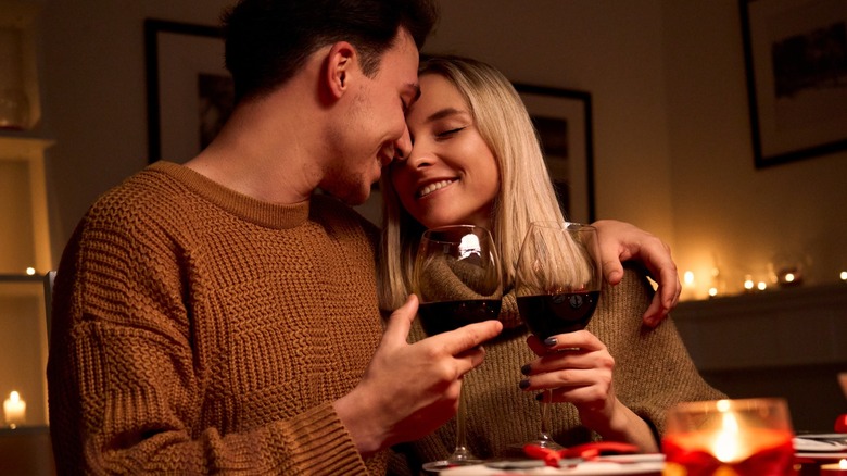 Smiling couple holding wine glasses