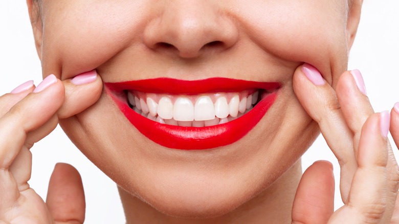 Woman with red lipstick smiling