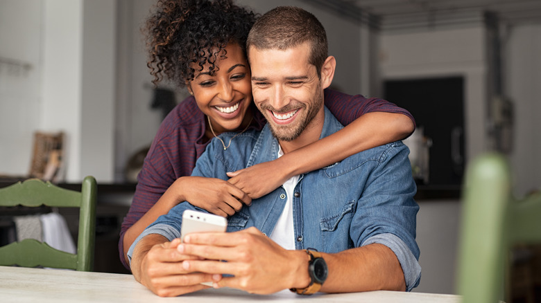 couple smiling at a phone