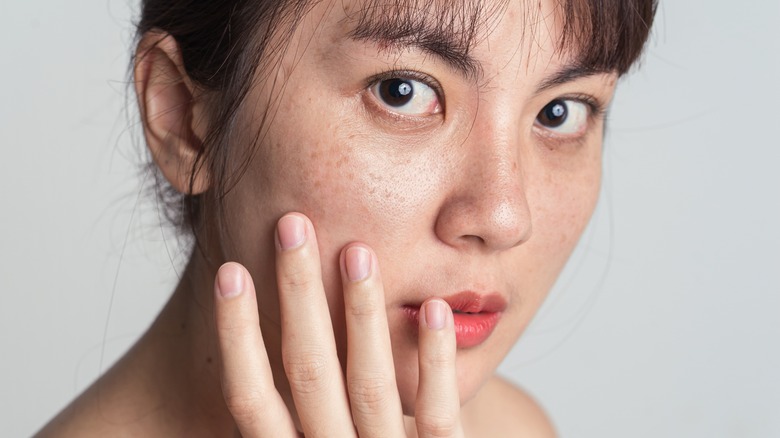 Woman applying skincare product