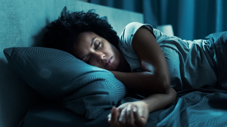 Black woman sleeping in bed