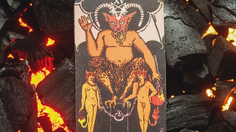 Devil tarot card sitting on embers