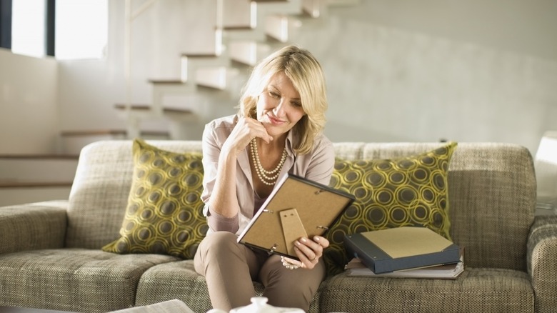 Woman smiling at picture frame