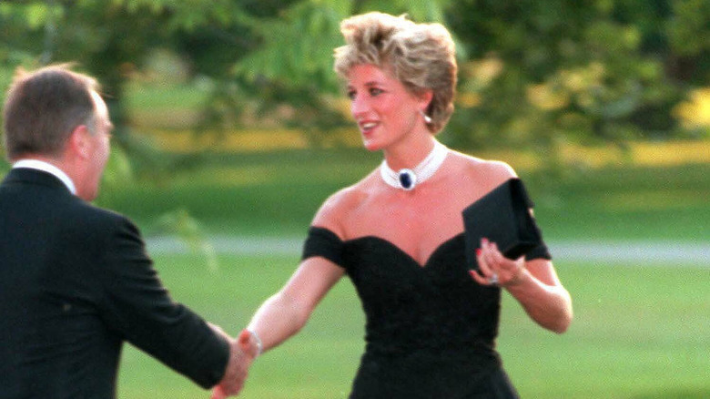 Princess Diana shaking hands in her "revenge dress"