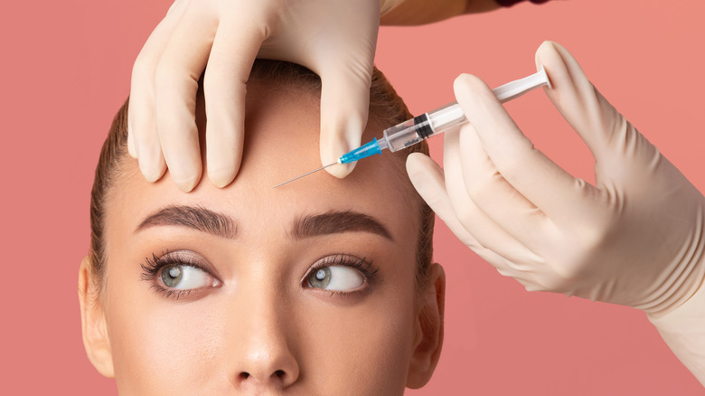 Close up of woman receiving forehead filler treatment