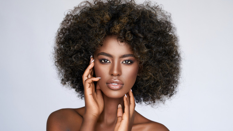 Curly-haired model posing