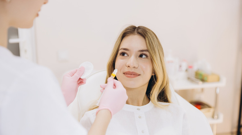 A cosmetologist holding a botox injection which is a good substitute for lip fillers