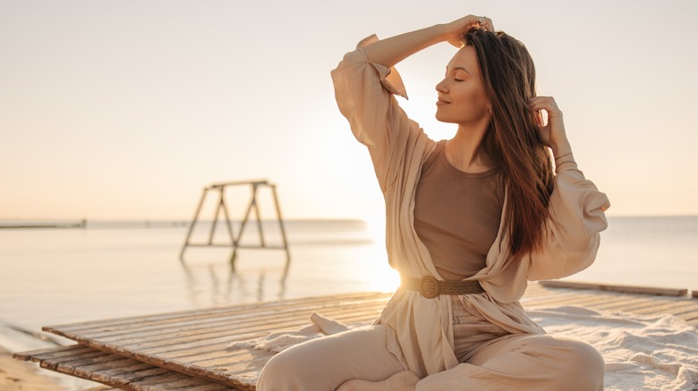 Woman sitting on pier