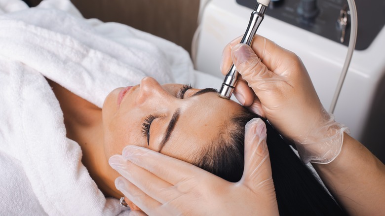 woman receiving microdermabrasion facial