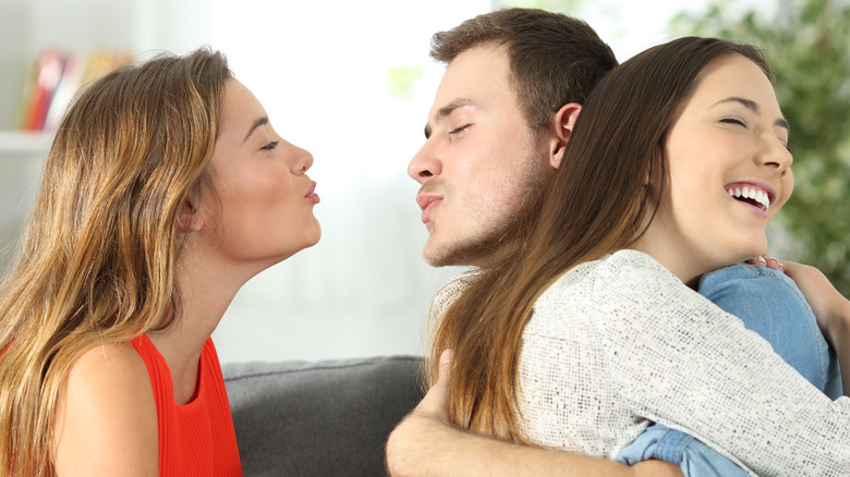 man with two women