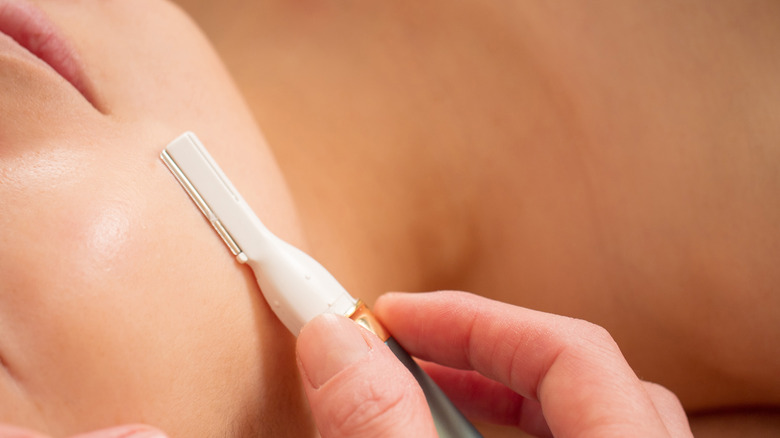 Woman getting treatment razor