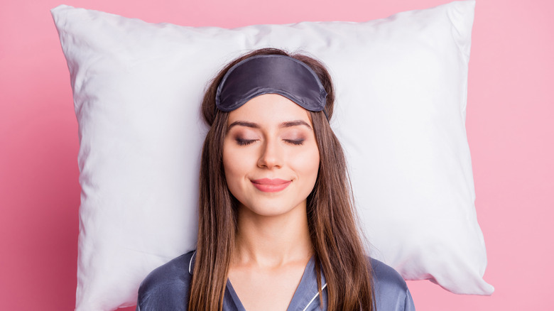 Woman sleeps with sleep mask