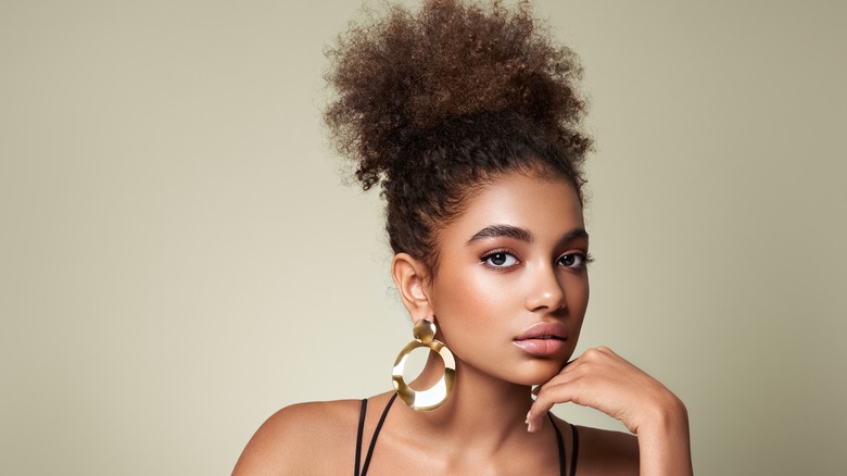 woman wearing high afro puff