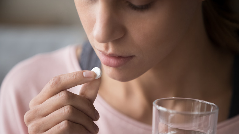 Woman taking allergy pills