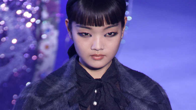 deconstructed black eyeliner with headband and coat