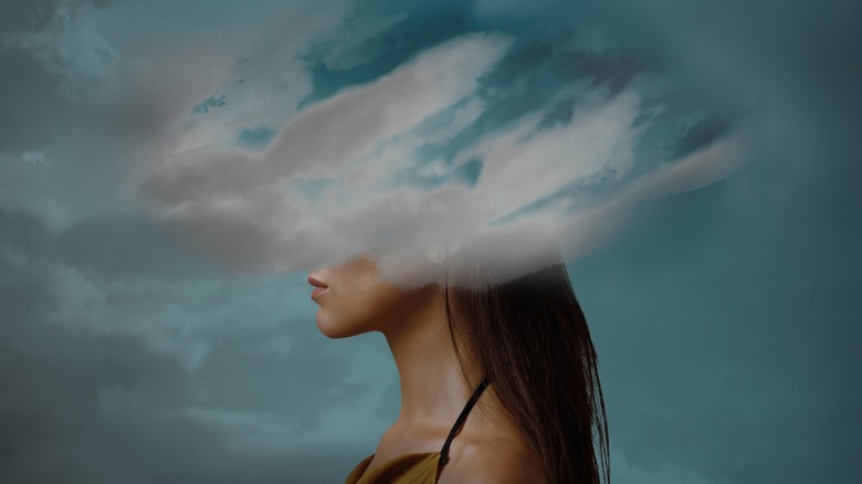 Woman with head in clouds