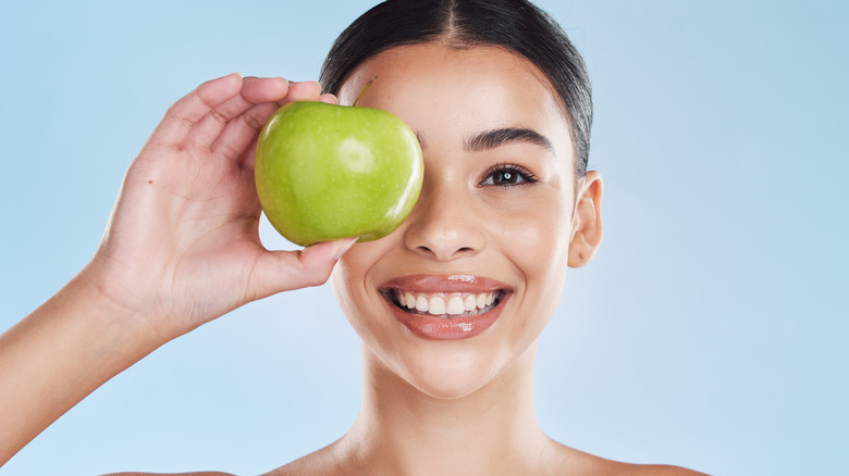 woman holding apple