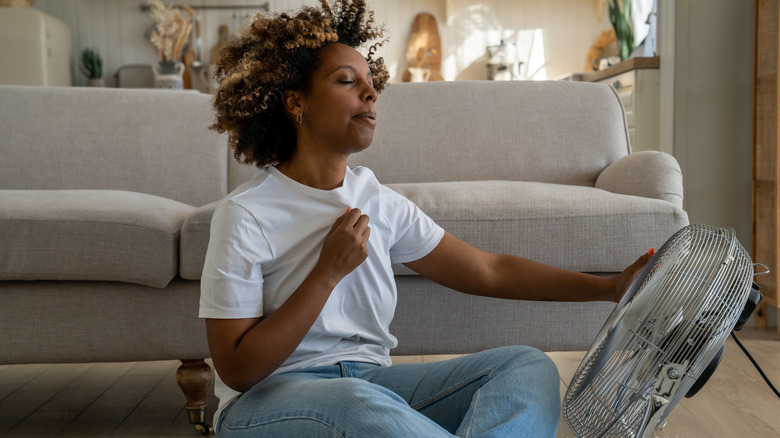 Woman sitting in front of a fan