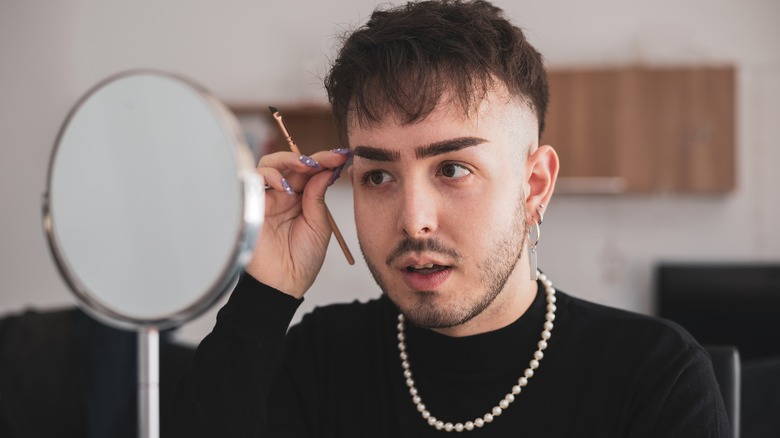 man applying makeup 