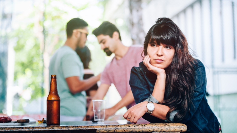 Unhappy woman sitting at bar