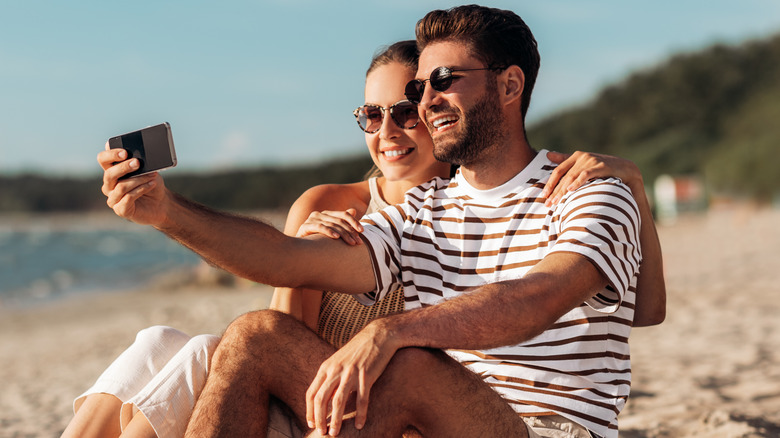 Couple taking selfie on the beach