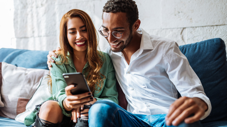 Woman showing man her phone