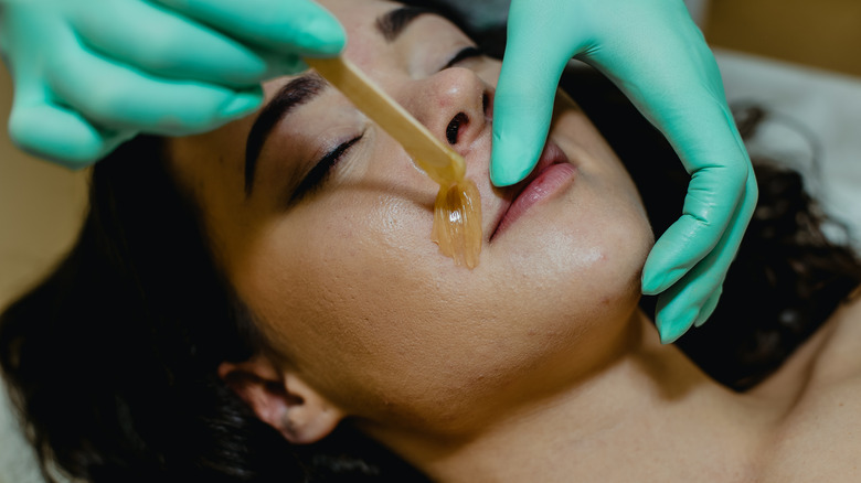 woman getting upper lip waxed