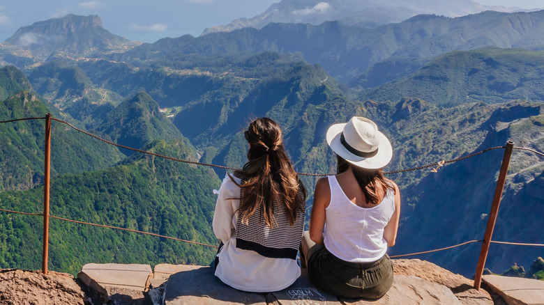 couple sitting on rock