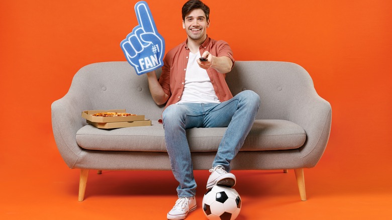man on sofa with pizza