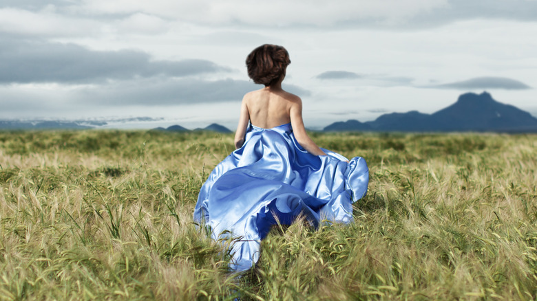 Woman running away in a field