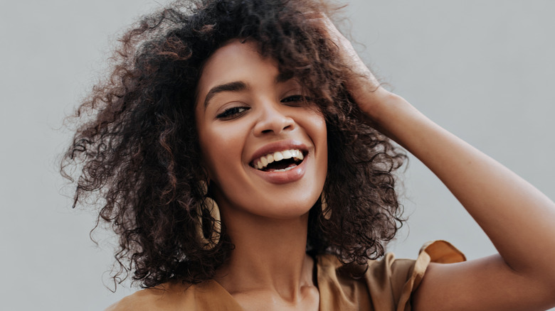 smiling woman with curly hair