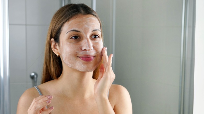 Applying skincare product to face