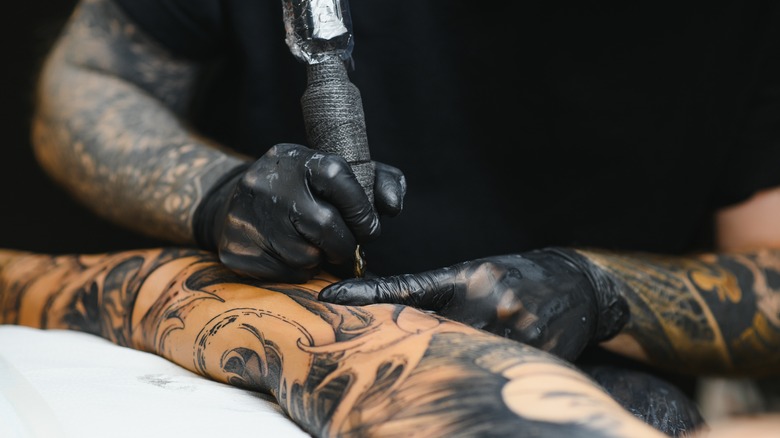 Tattooer giving a tattoo