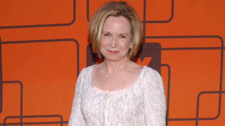 Debra Jo Rupp wearing a white outfit with a bob haircut