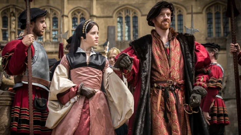 Claire Foy and Damian Lewis holding hands while filming 