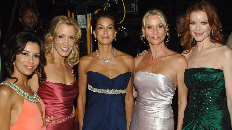 Eva Longoria, Felicity Huffman, Teri Hatcher, Nicollette Sheridan, and Marcia Cross posing in formal gowns promoting 