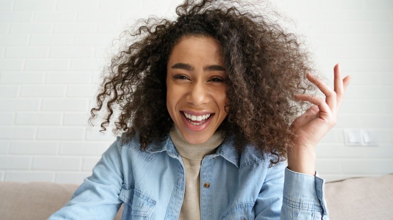 Woman smiling from computer camera