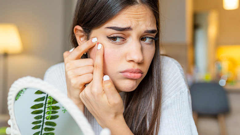 stressed girl popping pimple