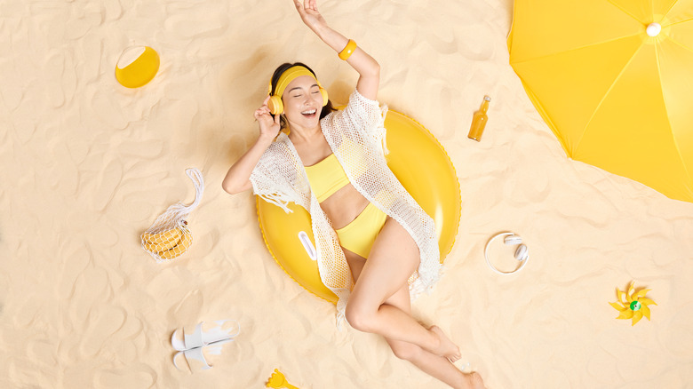 Woman headphones on beach 