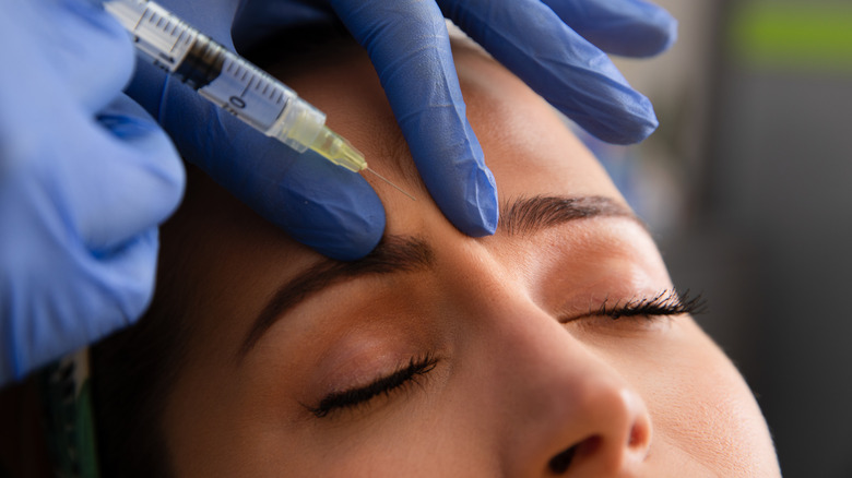 Person receiving injection into forehead