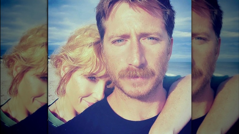 Kelly Reilly with her husband, Kyle Baugher, on a beach